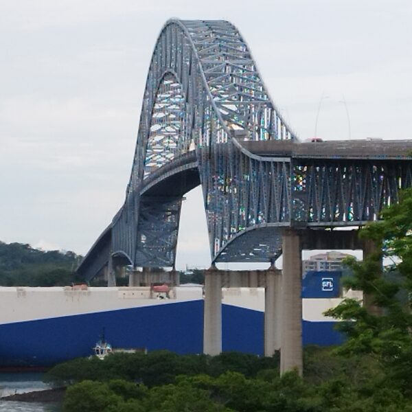 Ship crossing under bridge